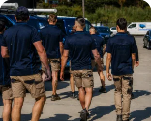 Plumbers walking to their service vans on a Homebush job