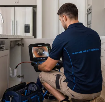 Clearing a blocked sink at a Homebush property